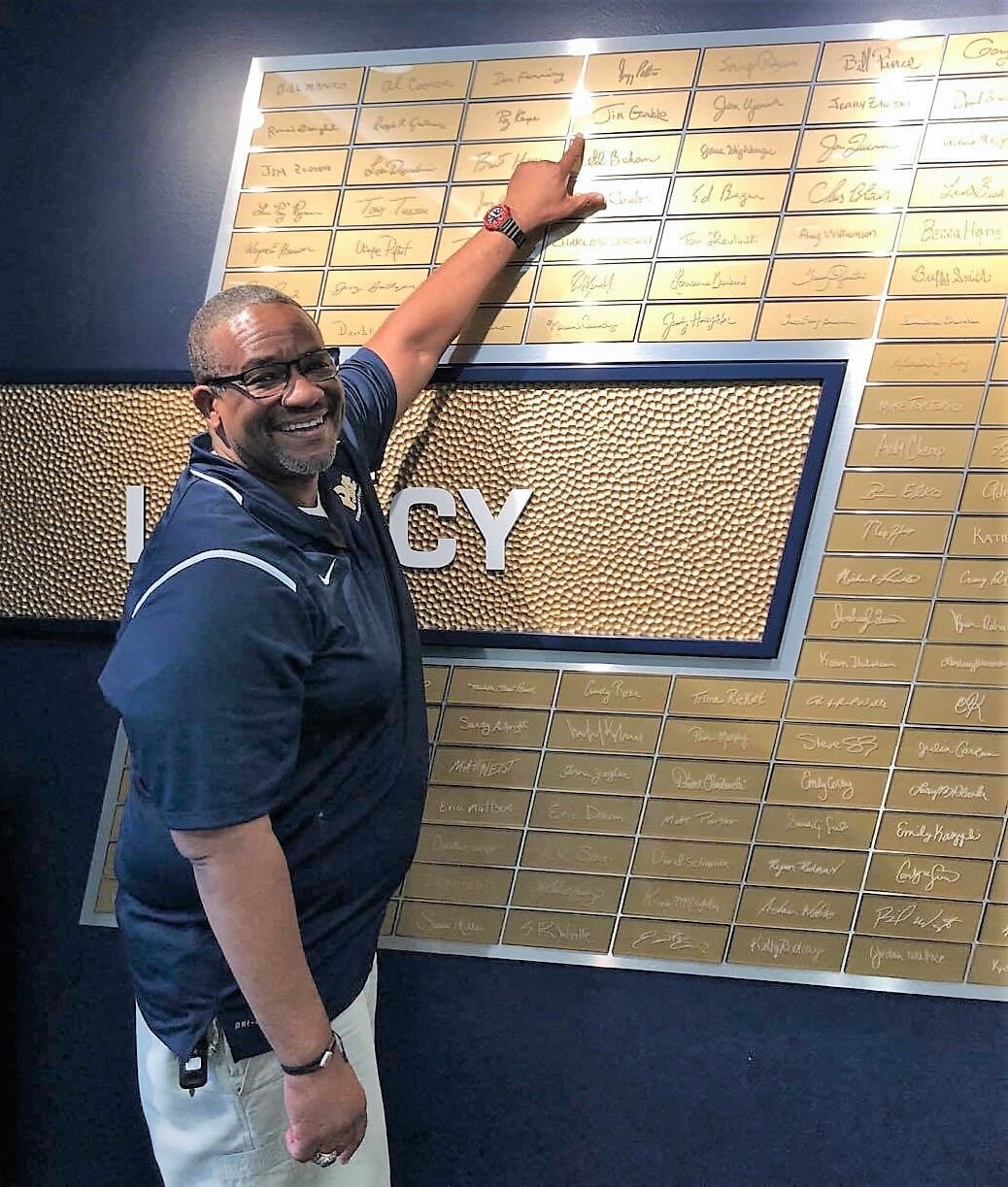 Jim points to his name on the Pitt Legacy Wall