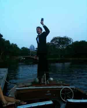 In a tux on a wooden boat