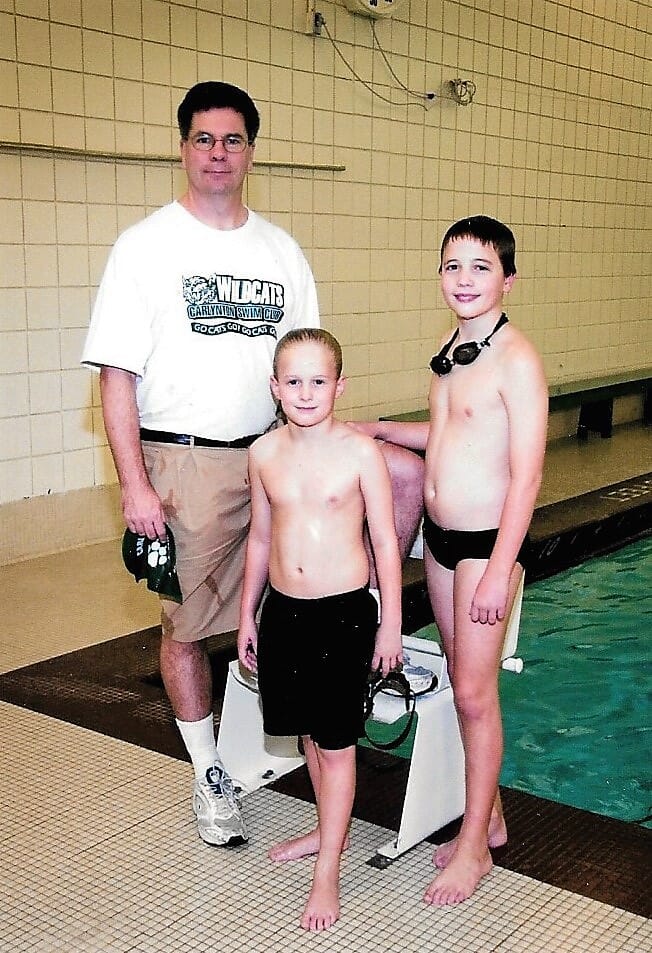 Coach, dad and two sons, in swim suits
