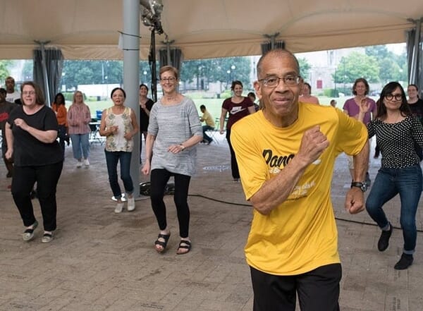 Roland-with-CP-n-Elaine-in-front-min Catherine and Elaine in the front row, left and right, follow along with the dance leader, Roland. May he rest in peace. He was a great community leader and we worked together for many summers with PPS students at Summer Dreamers.